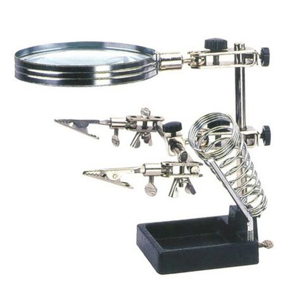 Elektroniikan juotosapuri suurennuslasilla ja pidikkeellä